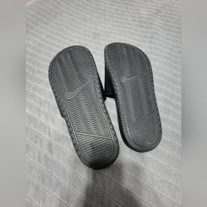 Black pink lettered nike slides